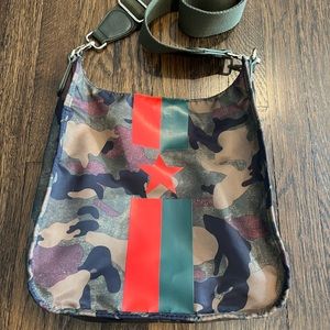 Ahdorned camo pocketbook with red and green strip and star